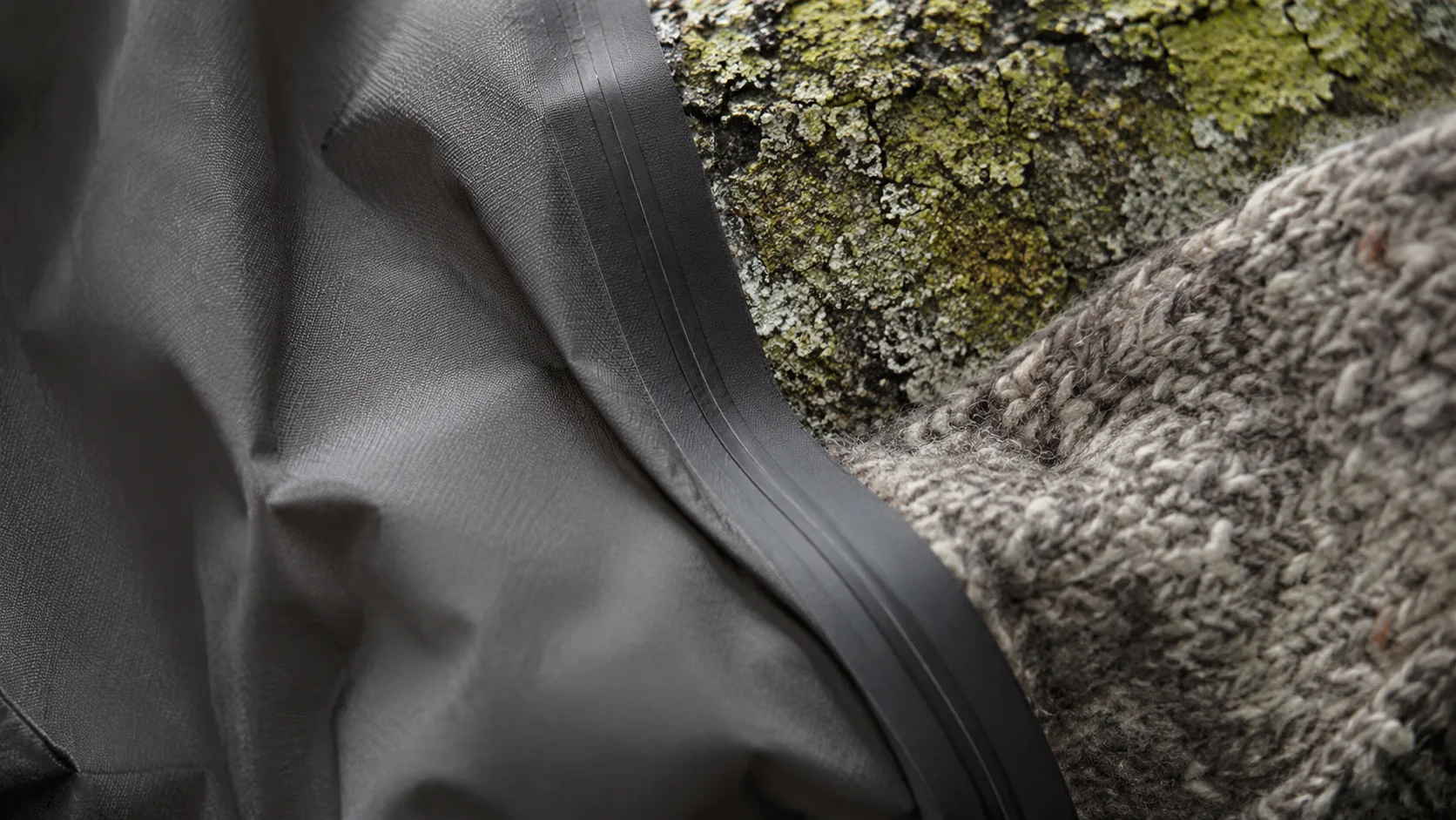 Close detail of technical fabric against lichen covered stone